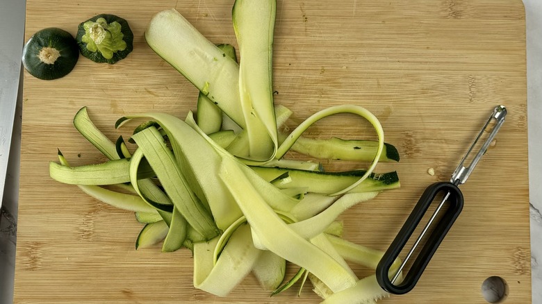 peeled zucchini ribbons on board