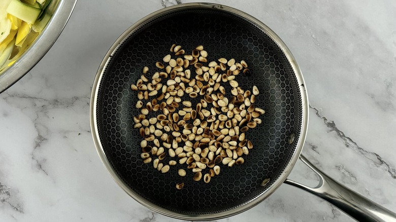 toasted pine nuts in skillet