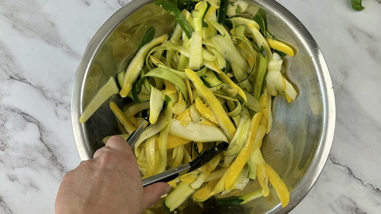 tossing squash with vinaigrette