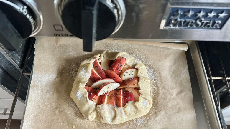 placing peach galette in oven