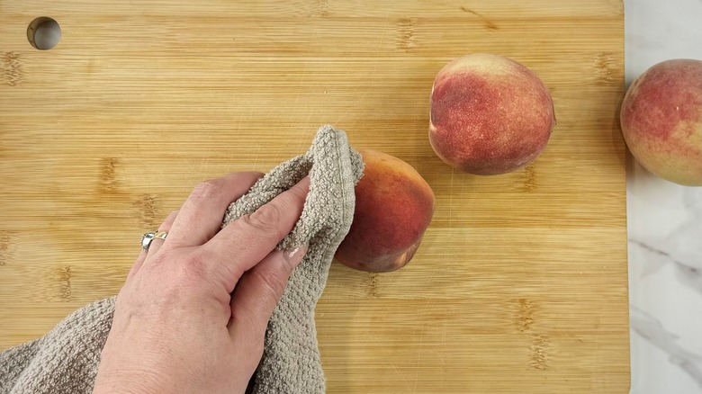 drying peaches with tea towel