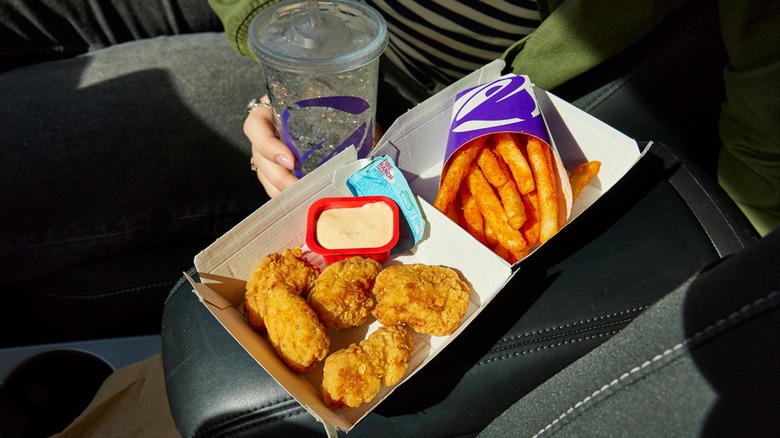 Taco Bell nuggets in clamshell box with Nacho Fries and drink