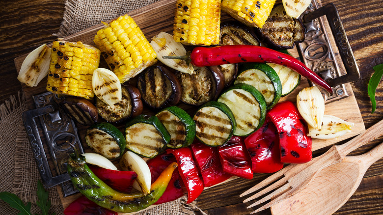 Grilled summer vegetables on wood board