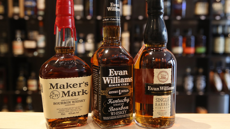 three bottles of bourbon on counter