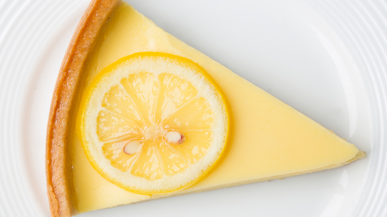 Lemon pie slice on plate overhead view.