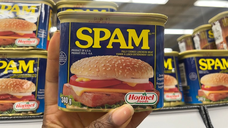 person holding can of Spam