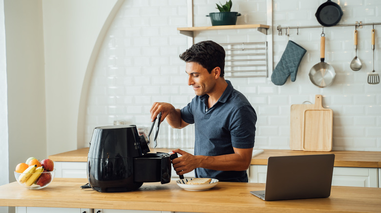 Person using an air fryer 