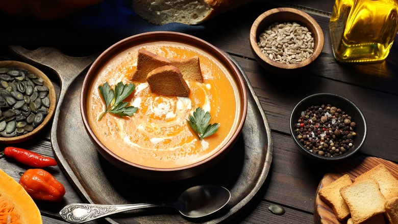 pumpkin soup in wood bowl with croutons