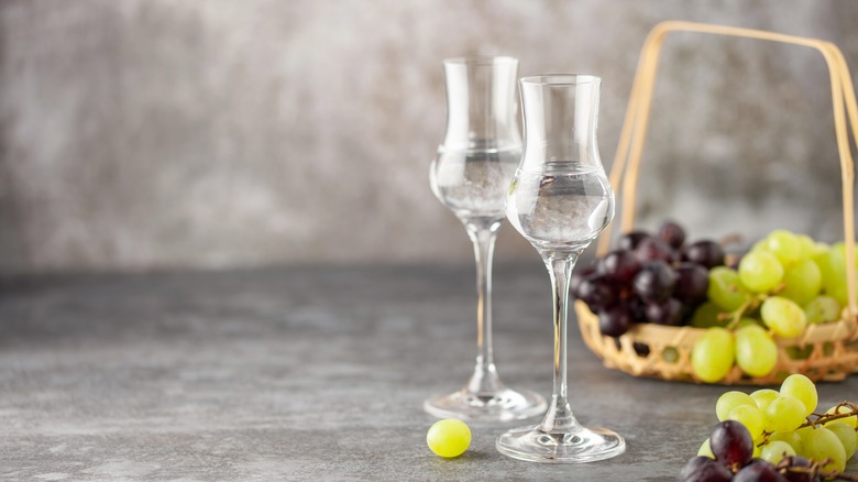 Two tulip shaped glasses half-filled with a clear liquid