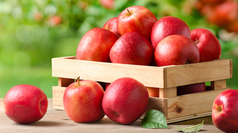 Red apples outside in wooden box