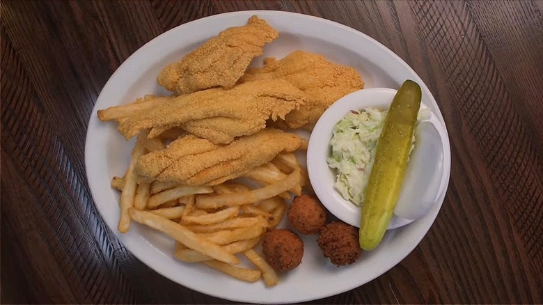 Fried catfish dinner on white plate served at Dondie's, overhead view