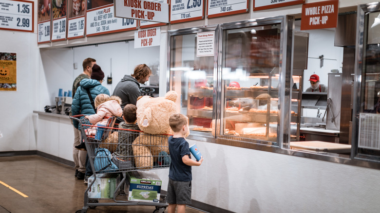 Family with cart purchasing food at Costco food court