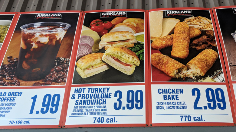 A Costco menu board shows the old price for a turkey sandwich