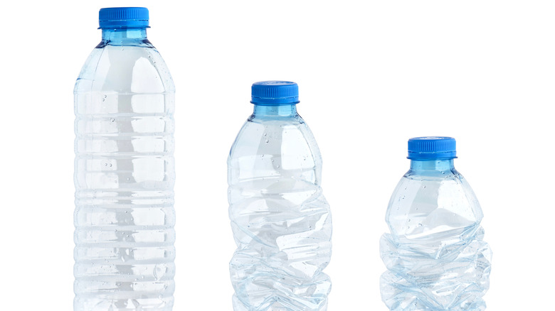 Plastic water bottles are in stages of being crumpled