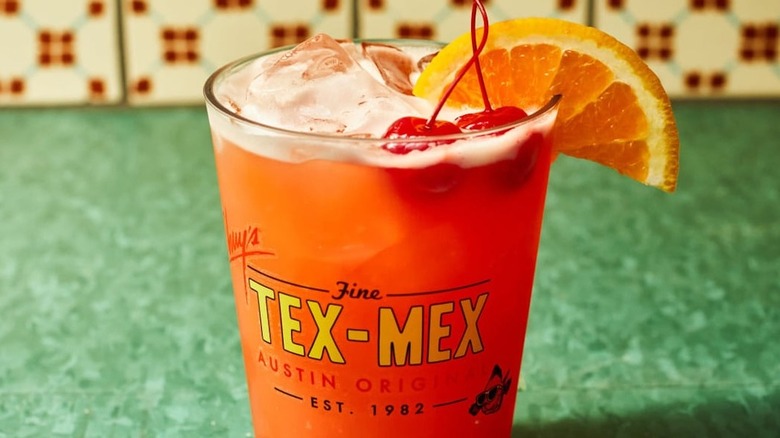 orange cocktail in a pint glass that reads 'Chuy's Fine Tex-Mex, Austin Original, est. 1982'