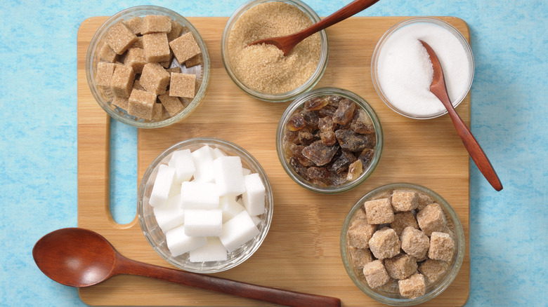 Various sugars on wood cutting board