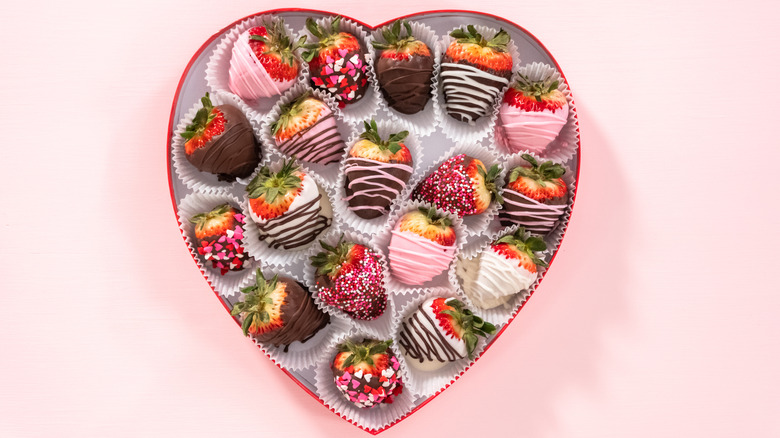 chocolate-covered strawberries in a heart-shaped box