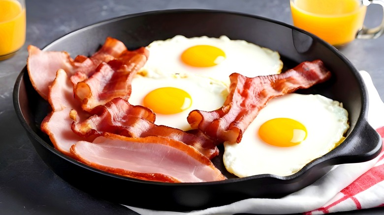 Cast iron pan with eggs, bacon, and ham