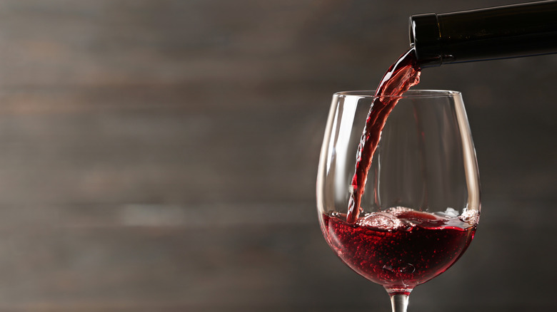 Wine being poured into a glass with blurred background