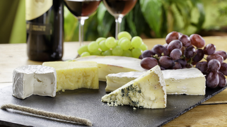 Person holding cheese in plastic container