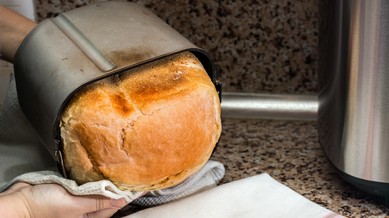 Removing cooked bread from bread machine