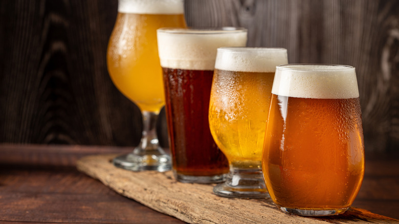 Variety of beer in different glasses on table.