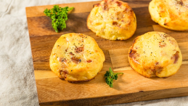 Sous vide egg bites stacked on a wooden board