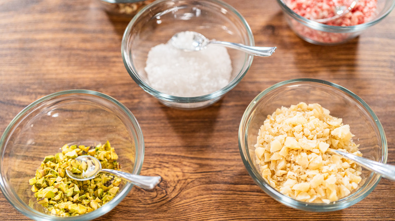 Cookie decorating supplies in glass bowls on wood table