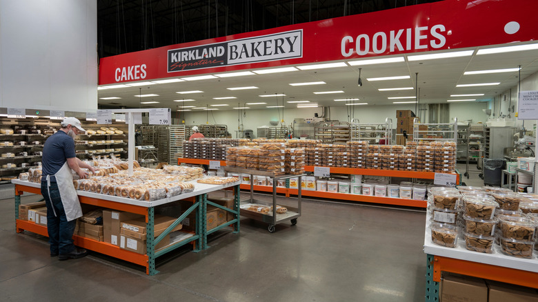 Employee stocking good in Costco bakery section.