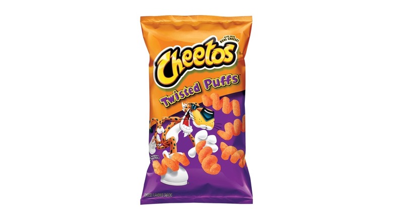 An orange-and-purple bag of Cheetos Twisted Puffs on a black background.