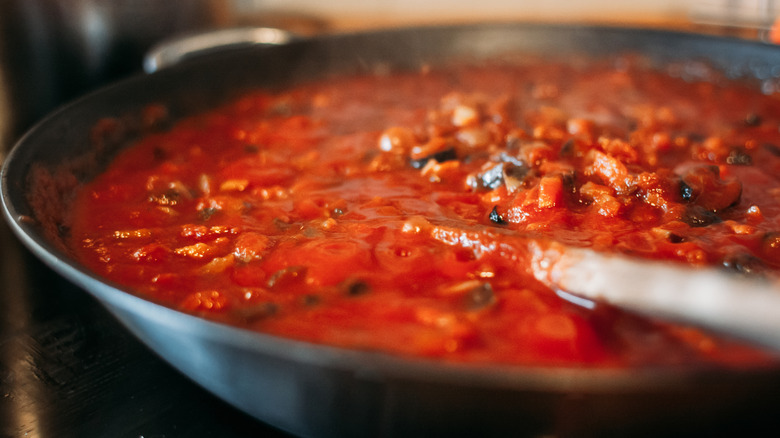 Simmering tomato sauce being cooked down