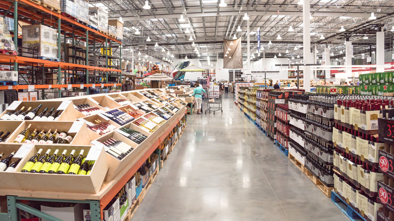 Person shopping inside liquor section of a Costco warehouse.