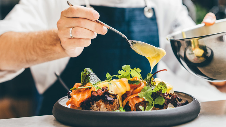 Chef adds a mother sauce to a dish