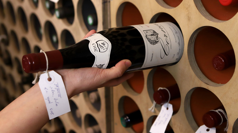 Selecting French wine from a cellar