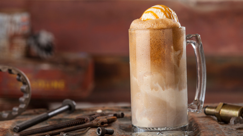 Root beer float with a drizzle of caramel sauce with an industrial background.