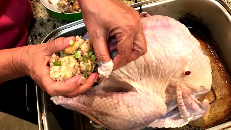 adding stuffing to turkey