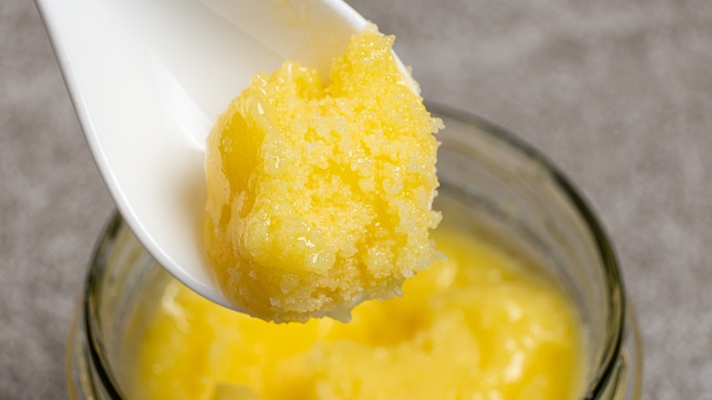 Ghee on spoon from jar