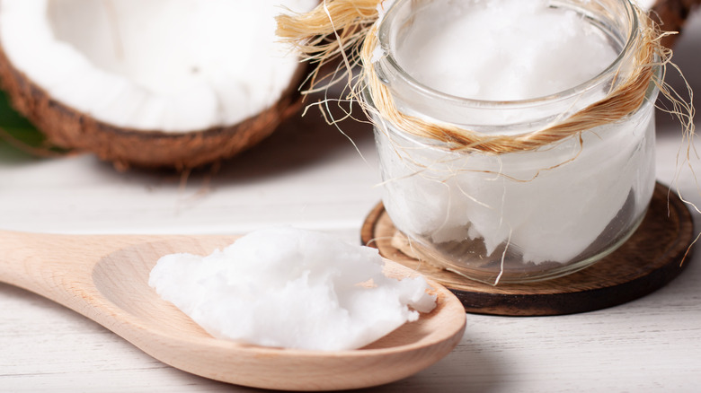 solid coconut oil on wooden spoon