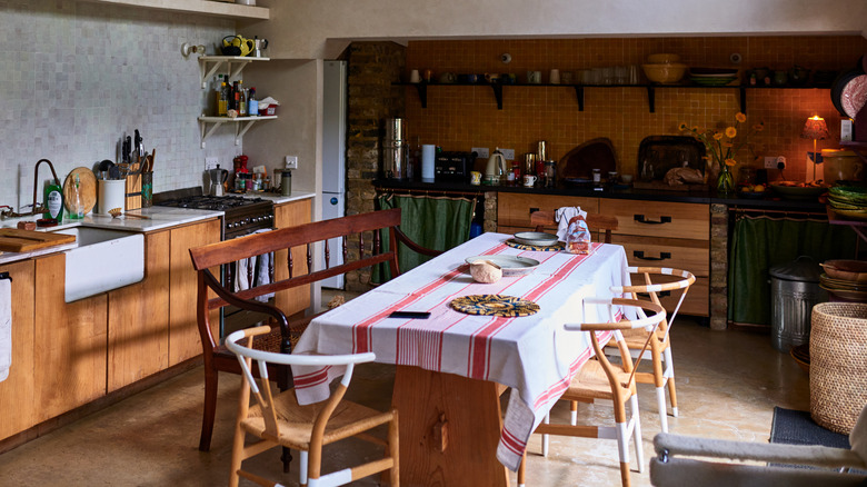 Cozy, rustic kitchen with a table in the middle.