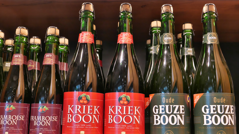 various bottles of lambic beer on a shelf