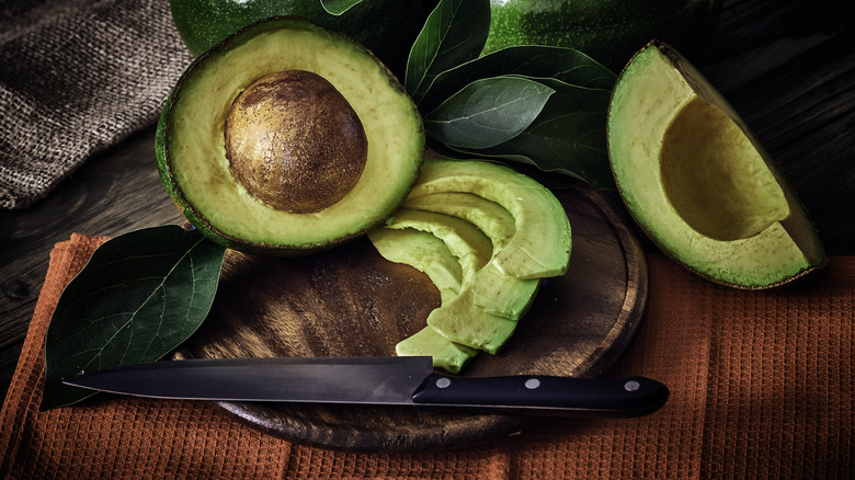 slightly browned avocado slices next to metal knife