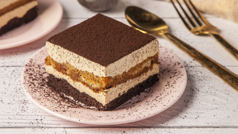 Tiramisu dusted with cocoa brass silverware