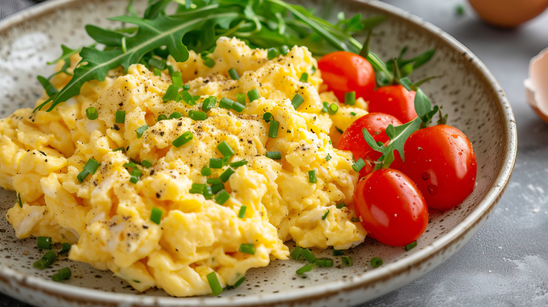 Scrambled eggs garnished with herbs and seasonings.