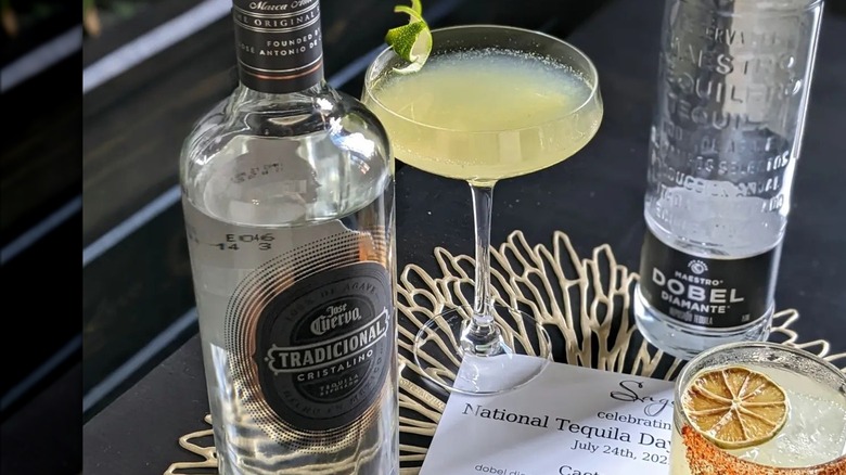 Bottle of cristalino tequila with cocktails