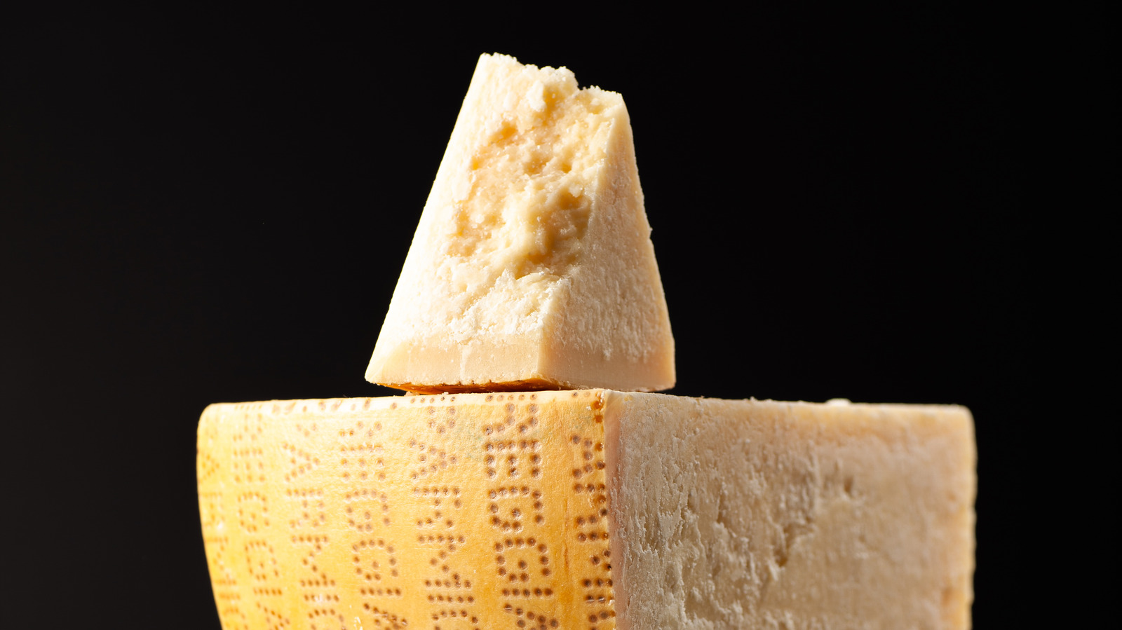 The Reason Authentic Parmesan Cheese Wheels Are Imprinted With Dots