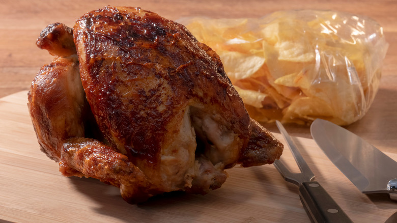 Rotisserie chicken on wood cutting board