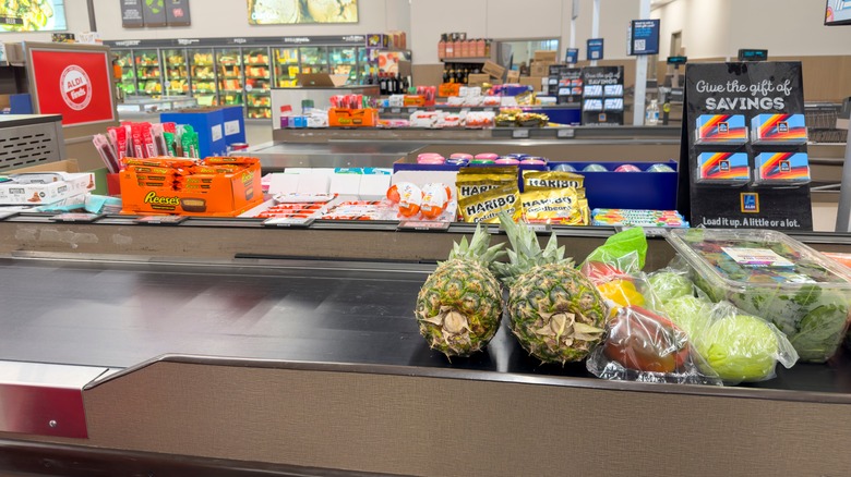 Checkout conveyor belt with foods inside a Los Angeles Aldi store.