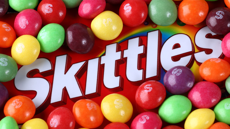 Skittles candy spread over packaging