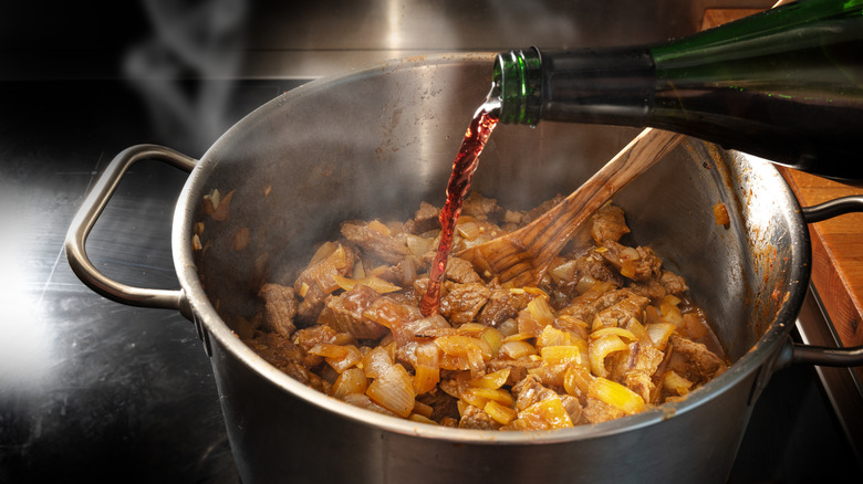 Wine poured into pot on stove