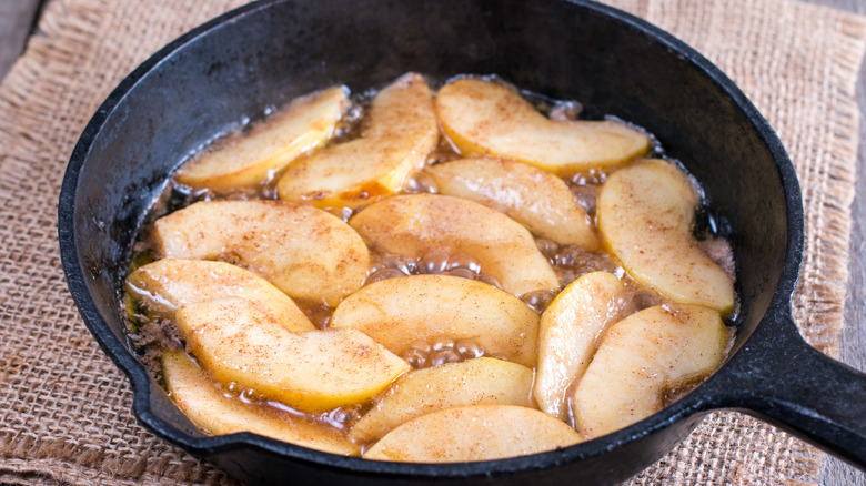 Cooking sliced apples in a cast iron skillet